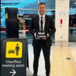 Chauffeur holding a name sign at Melbourne Airport for a private pickup