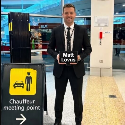 Chauffeur holding a name sign at Melbourne Airport for a private pickup